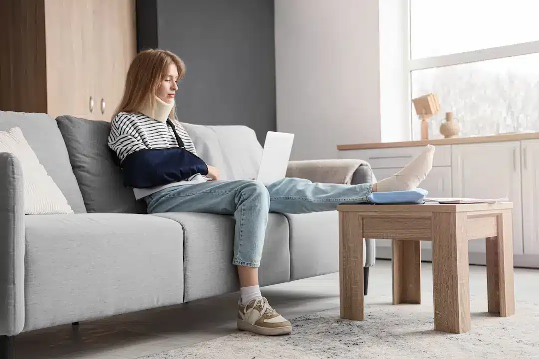 Woman with many injuries researching a personal injury lawyer